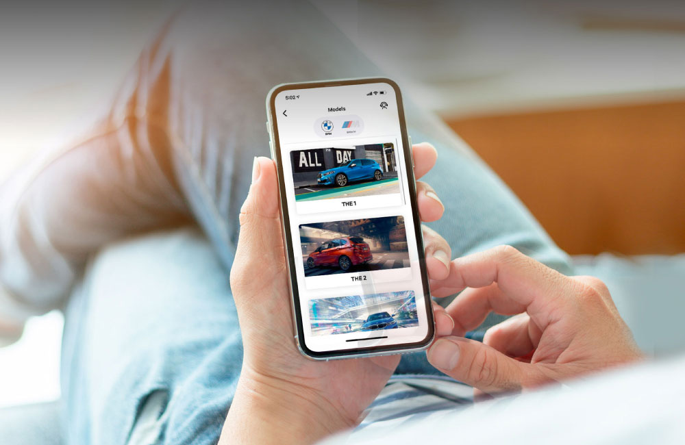 Man browsing BMW App on mobile phone
