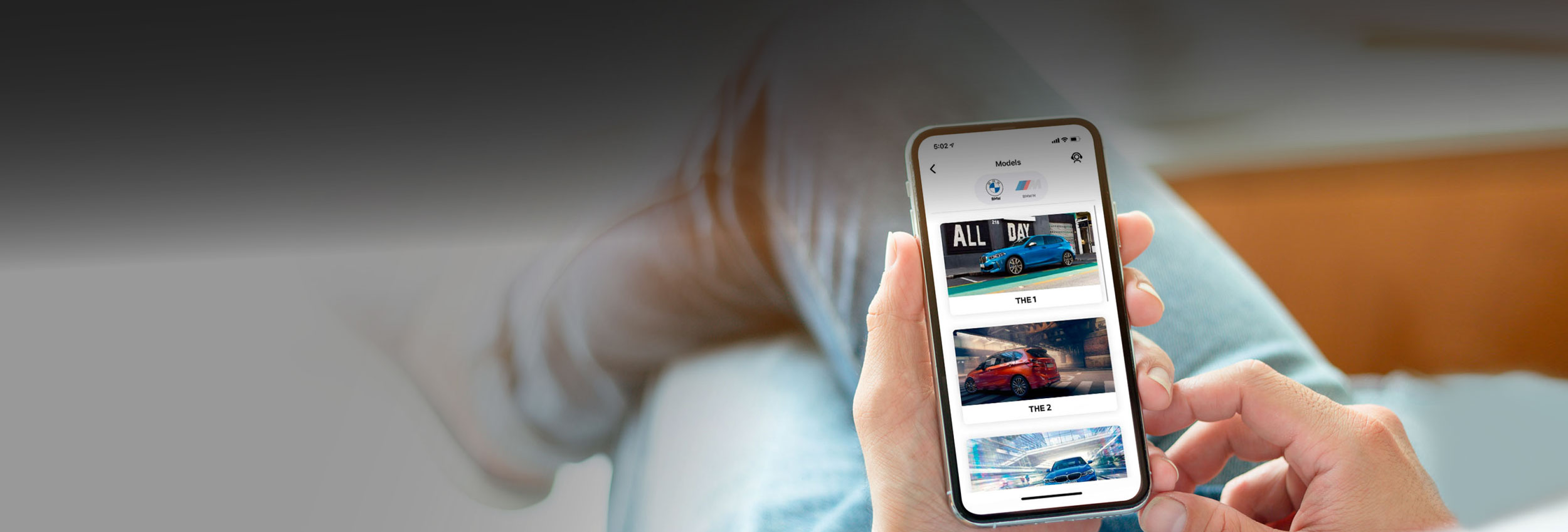 Man browsing BMW App on mobile phone